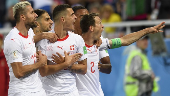 Switzerland&#039;s midfielder Granit Xhaka, center, celebrates after scoring a goal with team mates Switzerland&#039;s midfielder Valon Behrami, Switzerland&#039;s defender Ricardo Rodriguez, Switzerl ...