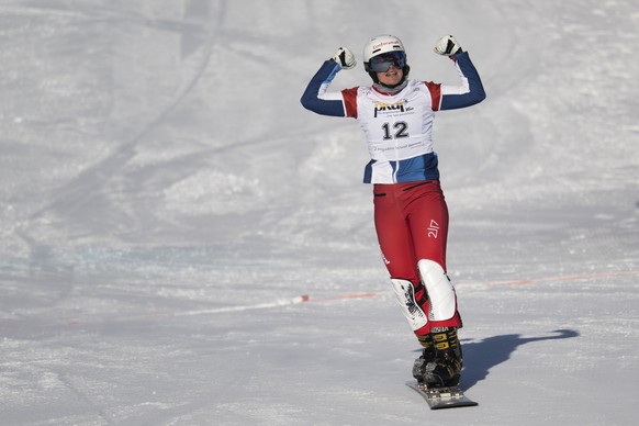 Julie Zogg of Switzerland reacts at the FIS Alpine Snowboard Parallel Giant Slalom race, on Saturday, January 8, 2022, in Scuol, Switzerland. (KEYSTONE/Gian Ehrenzeller)