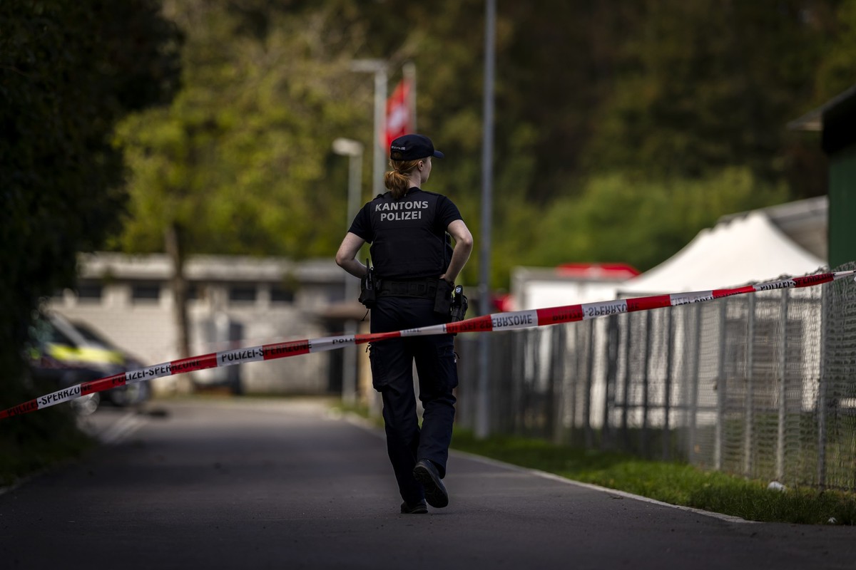 A police officer guards at the Schachen horse racing track, the site of a rave party, following a deadly shooting incident on Sunday, in Aarau Switzerland on Monday, August 31, 2026. (KEYSTONE/Michael ...