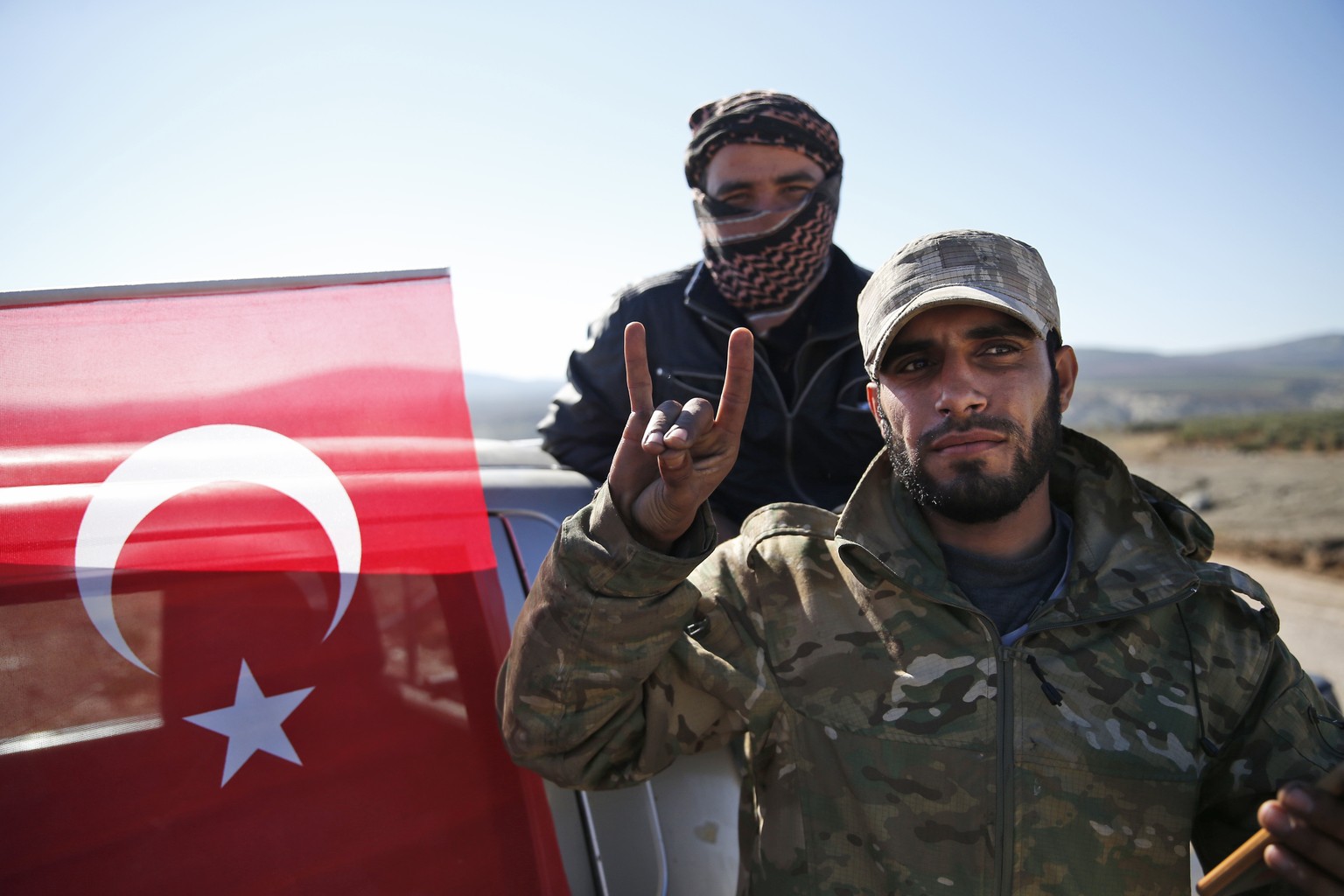 Turkey-backed Syrian opposition fighters of the Free Syrian Army wait to be driven towards the border with Syria, in the outskirts of the border town of Kilis, Turkey, Tuesday, Jan. 30, 2018. Turkey l ...