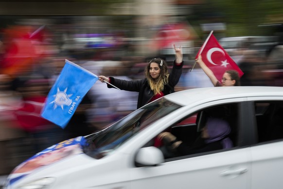 Supporters of the Turkish President Recep Tayyip Erdogan hold flags outside his house in Istanbul, Turkey, Sunday, May 28, 2023. President Recep Tayyip Erdogan, who has been at Turkey's helm for ...