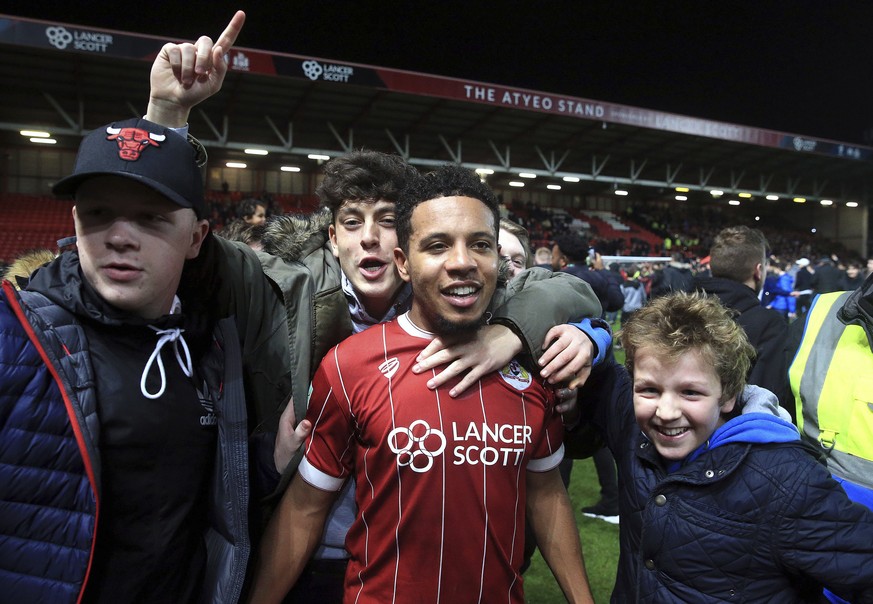 Bristol City&#039;s Korey Smith celebrates scoring his side&#039;s second goal of the game with fans after the final whistle in the English League Cup Quarter Final soccer match between Bristol City a ...