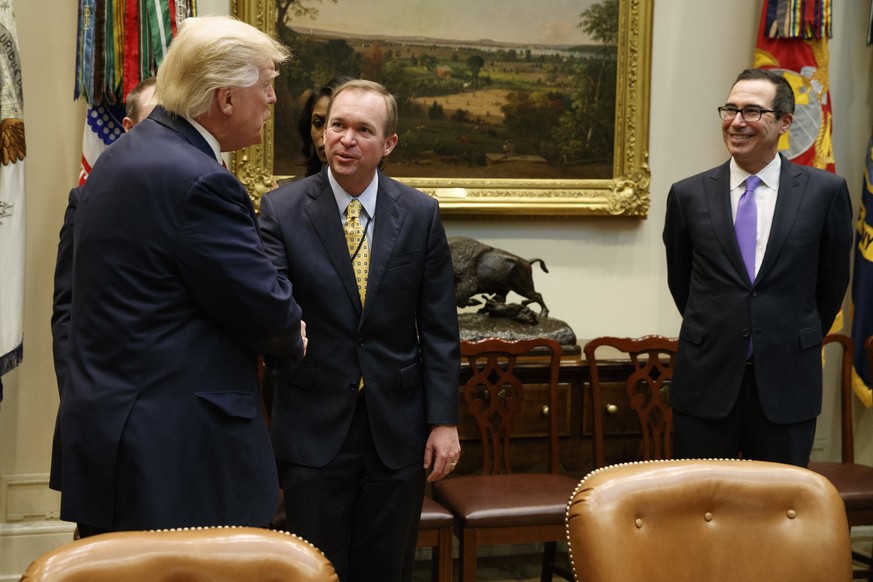 President Donald Trump talks with Budget Director Mick Mulvaney, center, and Treasury Secretary Steven Mnuchin during a meeting on the Federal budget, Wednesday, Feb. 22, 2017, in the Roosevelt Room o ...