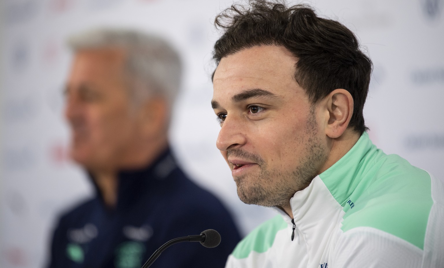 epa09100655 Switzerland&#039;s Xherdan Shaqiri speaks next to head coach Vladimir Petkovic at a press conference before a training session at the Kybunpark Stadium in St. Gallen, Switzerland, 27 March ...