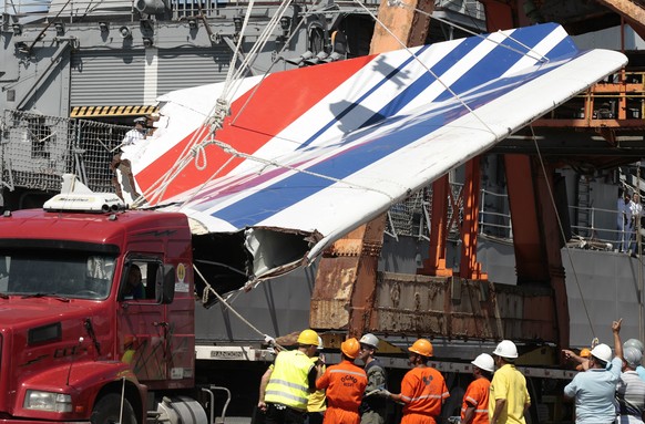 FILE -- In this June 14, 2009 file photo workers unload debris, belonging to crashed Air France flight AF447, from the Brazilian Navy's Constitution Frigate in the port of Recife, northeast of Br ...