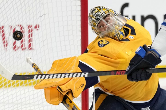 Nashville Predators goaltender Juuse Saros reaches for a shot that gets past him for a goal by Winnipeg Jets&#039; Mark Scheifele during the first period of an NHL hockey game Tuesday, April 9, 2024,  ...