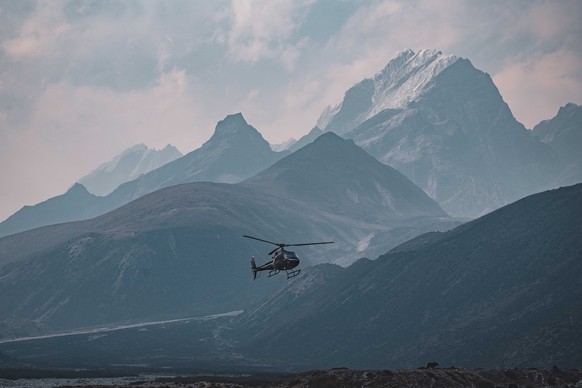 epa11334456 A handout photo made available by Seven Summit Trek shows a helicopter flying around Solukhumbu region of Mt. Everest in Nepal, 01 May 2024 (issued 12 May 2024). According to Seven Summit  ...