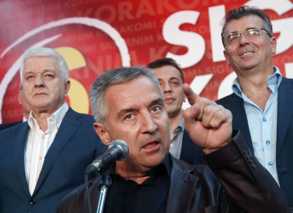 FILE - A Monday, Oct. 17, 2016 file photo of Montenegro&#039;s Prime Minister and long-ruling Democratic Party of Socialists leader Milo Djukanovic, center, speaking in his party headquarters, in Podg ...