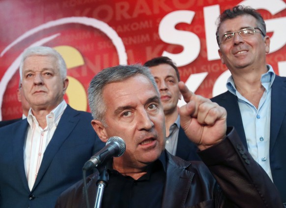 FILE - A Monday, Oct. 17, 2016 file photo of Montenegro's Prime Minister and long-ruling Democratic Party of Socialists leader Milo Djukanovic, center, speaking in his party headquarters, in Podg ...