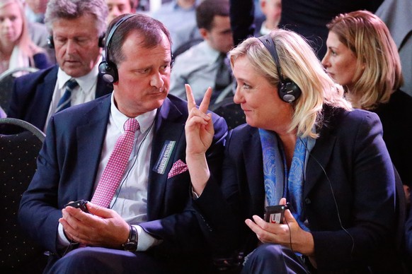 epa04932135 Marine Le Pen (R), the leader of the French far-right political party &#039;Front National&#039; (FN), gestures to her party&#039;s deputy leader Louis Alliot (L) as they attend a meeting  ...