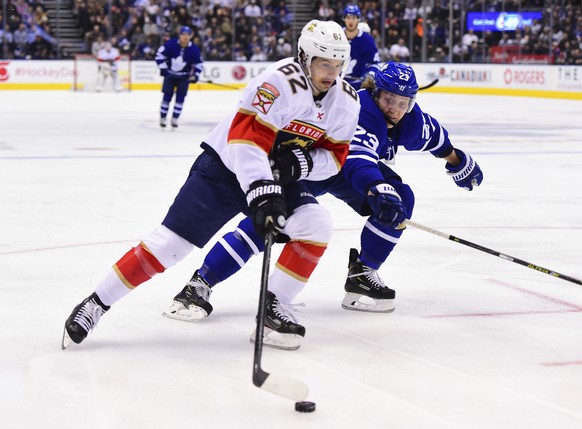 Florida Panthers center Denis Malgin (62) moves past Toronto Maple Leafs defenseman Travis Dermott (23) during the first period of an NHL hockey game, Monday, Feb. 3, 2020 in Toronto. (Frank Gunn/The  ...
