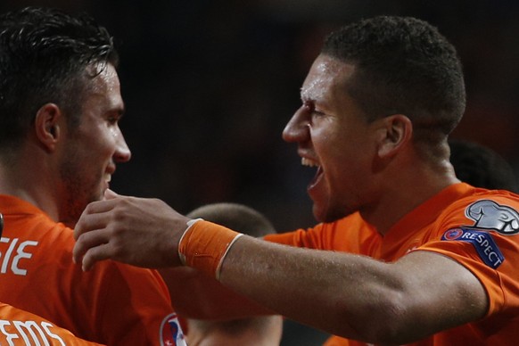 Netherlands&#039; Jeffrey Bruma, right, is congratulated by Netherlands&#039; Robin van Persie after Bruma scored his team&#039;s fourth goal during the Euro 2016 group A qualifying round soccer match ...