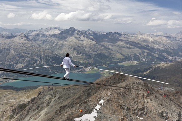 Swiss tightrope walker Freddy Nock walks on the carrying cable of the Corvatsch Cable Car downwards from the Corvatsch mountain station on 3,303 meters above sea level, near Silvaplana, eastern Switze ...