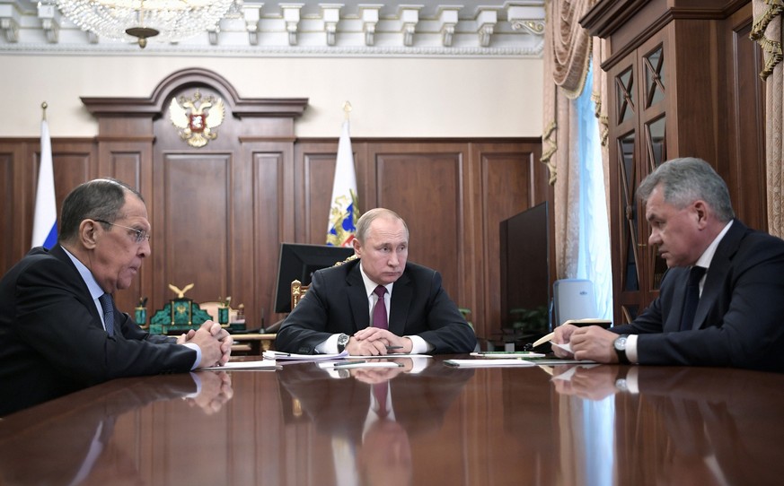 epa07337831 Russian President Vladimir Putin (C) during his meeting with Russian Foreign Minister Sergei Lavrov (L) and Russian Defence Minister Sergei Shoigu (R) in Moscow, Russia 02 February 2019. R ...