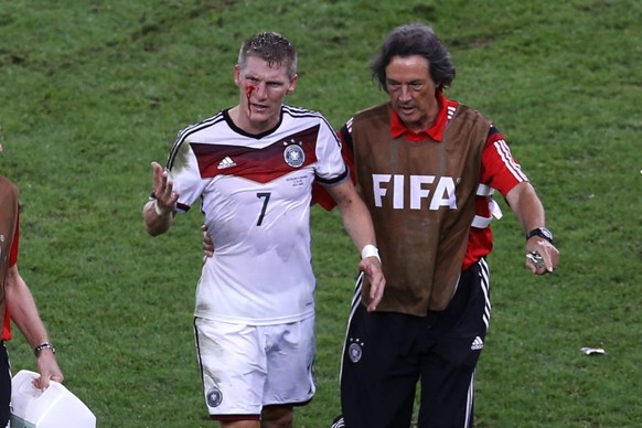 Football, Germany v Argentina. 2014 World Cup. The German player Bastian Schweinsteiger reacts next to Dr. Hans-Wilhelm M�ller-Wohlfahrt after receive injuired during the final match of the 2014 World ...