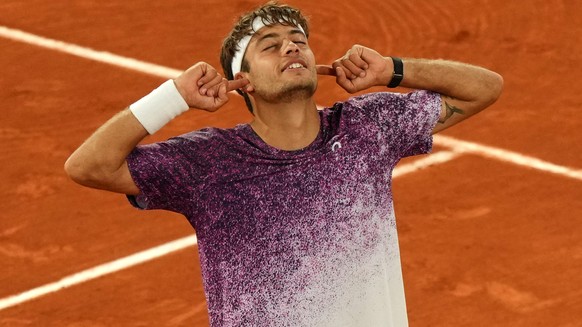 Italy's Flavio Cobolli reacts after winning the quarterfinal tennis match against Canada's Felix Auger-Aliassime at the French Open in Paris, Wednesday, June 3, 2026. (AP Photo/Aurelien Mori ...