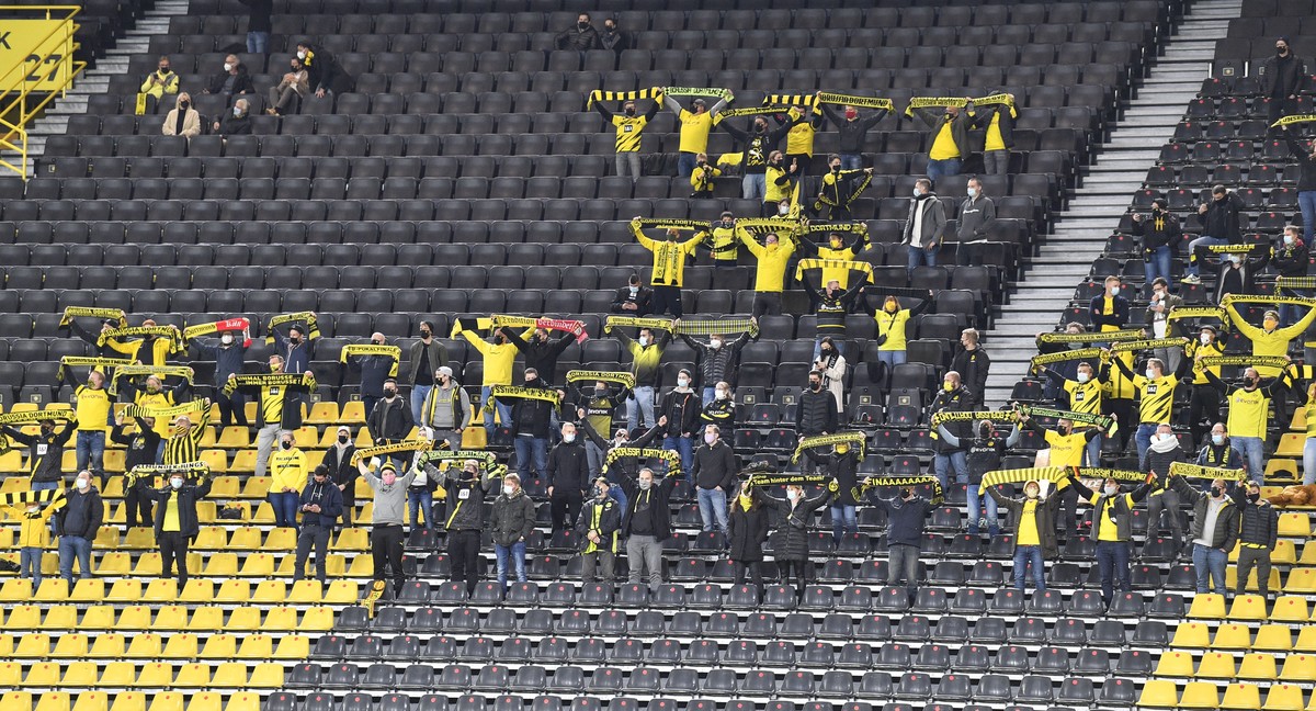 Dortmund's fans cheer during the German Bundesliga soccer match between Borussia Dortmund and FC Schalke 04 in Dortmund, Germany, Saturday, Oct. 24, 2020. (AP Photo/Martin Meissner, Pool)