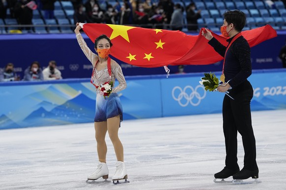 Gold medalists, Sui Wenjing and Han Cong, of China, pose during a medal ceremony after the pairs free skate program during the figure skating competition at the 2022 Winter Olympics, Saturday, Feb. 19 ...