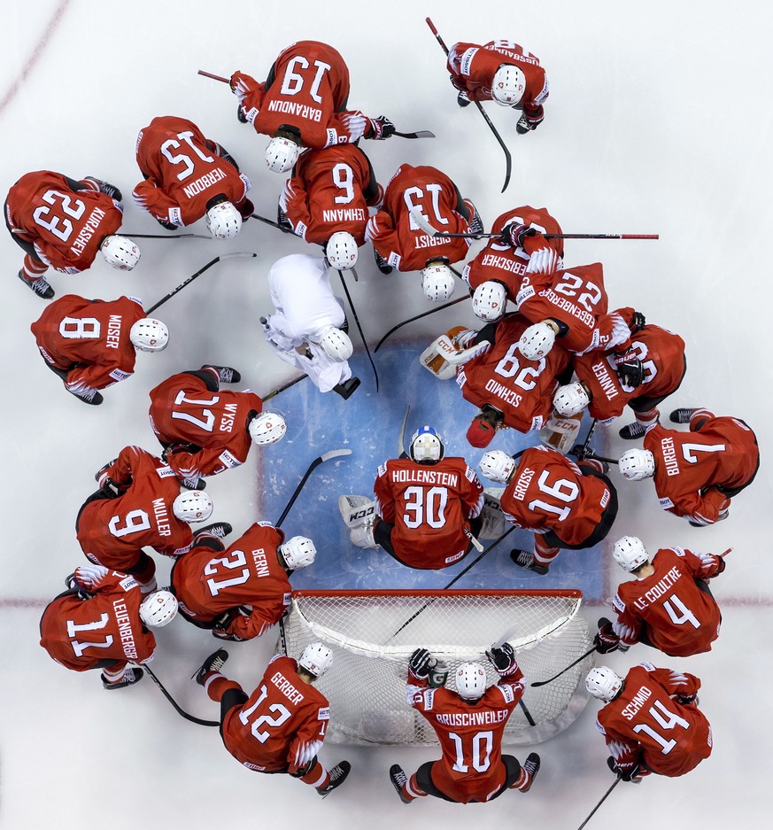 Switzerland players gather around goalie Luca Hollenstein (30) before semifinal IIHF world junior hockey championship game action against Finland in Vancouver, British Columbia, Friday, Jan. 4, 2019.  ...