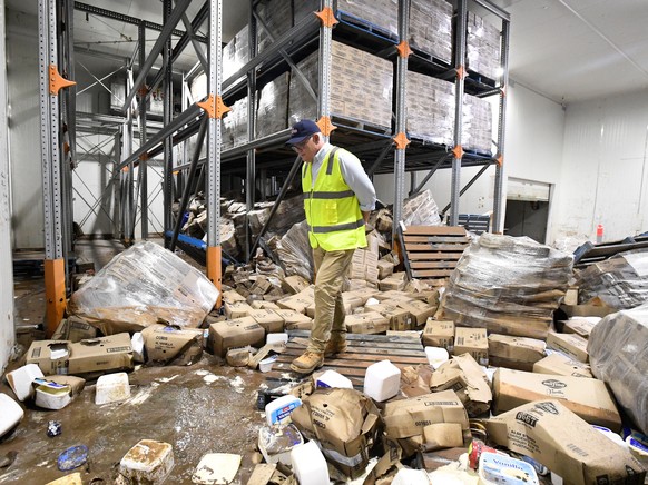 epa09811879 Prime Minister Scott Morrison inspects flood damage at the Norco Ice Cream Factory in Lismore, NSW, Australia, 09 March 2022. Prime Minister Scott Morrison has visited flood devastated reg ...