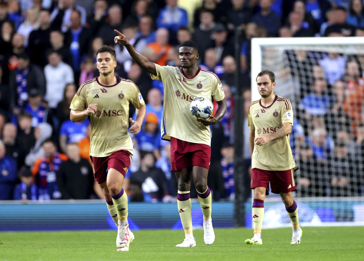 Servette FC's Chris Bedia, center, celebrates after scoring during the Champions League third qualifying round, first leg match between Rangers FC and Servette FC at the Ibrox Stadium, Glasgow, S ...