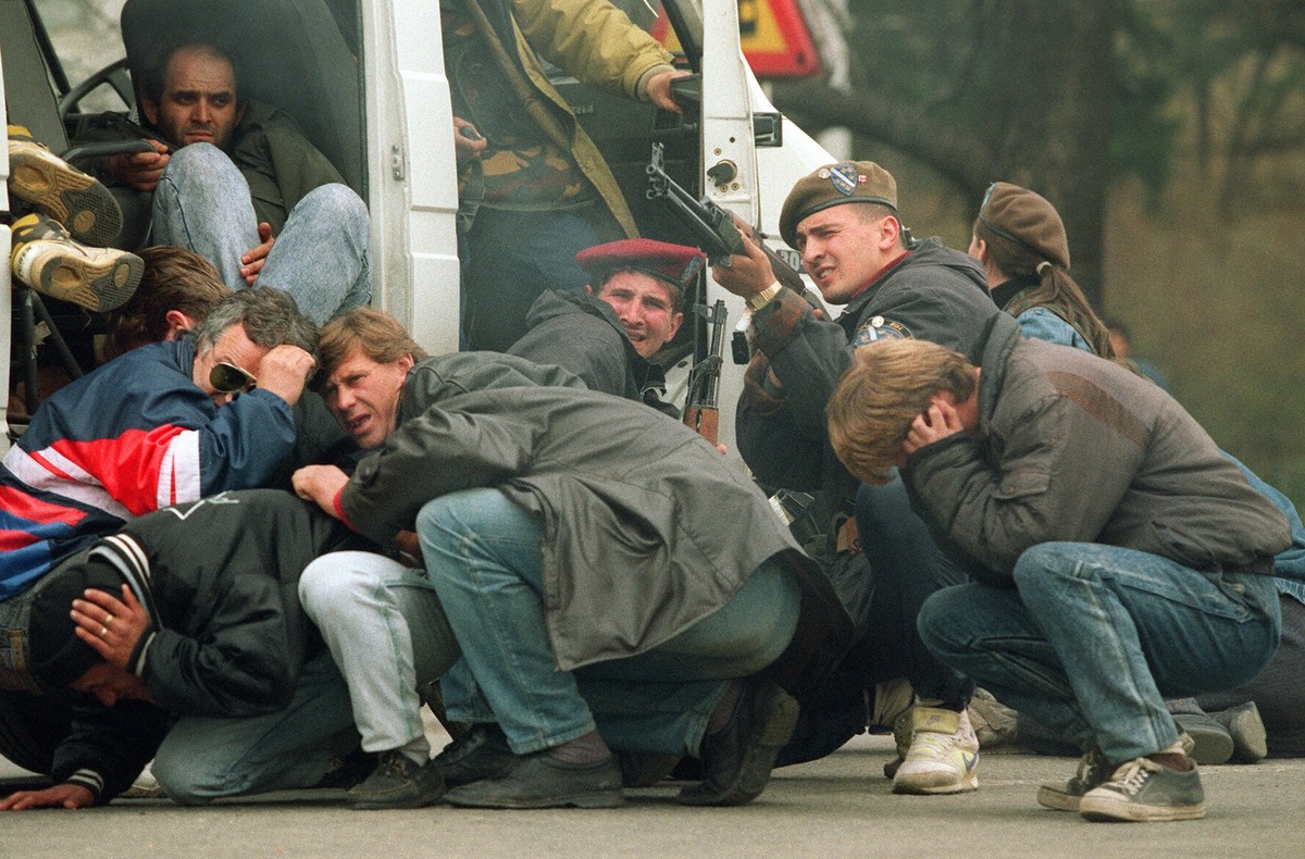 A Bosnian special forces soldier returns fire April 6, 1992 downtown Sarajevo as he and civilians come under fire from Serbian snipers. The Serb extremists were shooting from the roof of a hotel at a  ...
