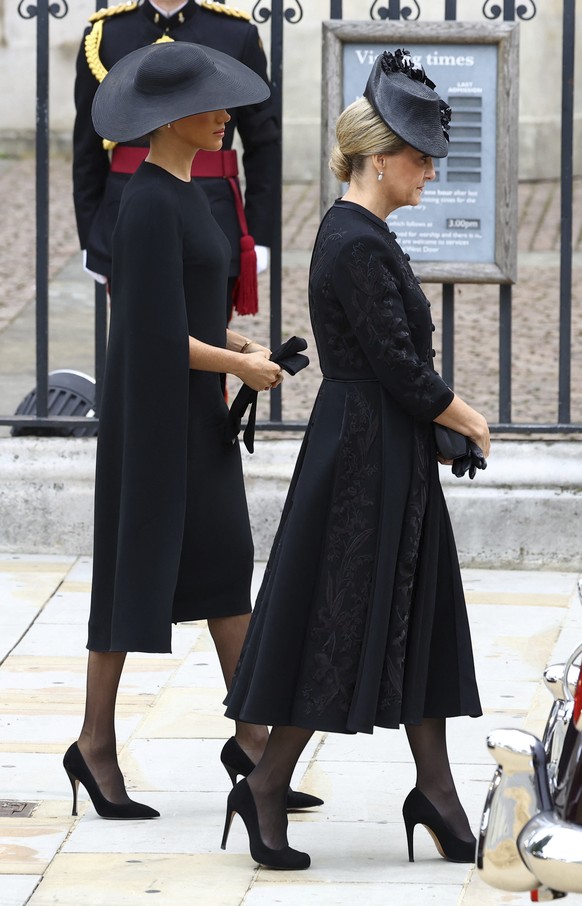 Britain's Sophie, Countess of Wessex, and Britain's Meghan, Duchess of Sussex walk outside the Westminster Abbey on the day of Queen Elizabeth II funeral, in London Monday, Sept. 19, 2022. (Hannah McK ...