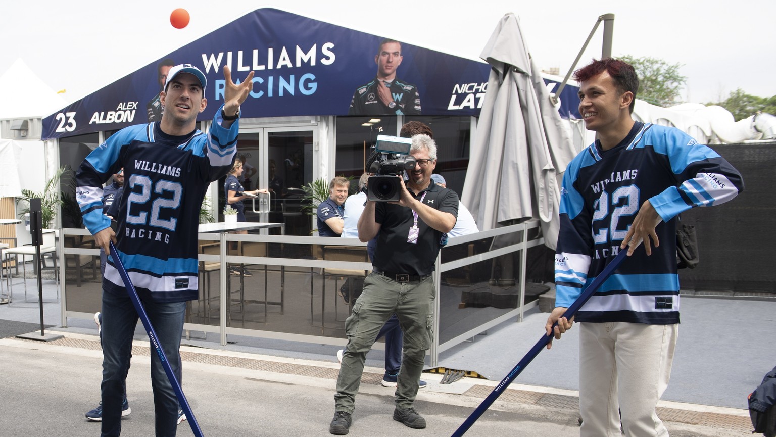Williams drivers Nicholas Latifi, left, and Alex Albon try their hand at ball hockey at the Formula 1 Canadian Grand Prix auto race, Thursday, June 16, 2022 in Montreal. (Graham Hughes/The Canadian Pr ...