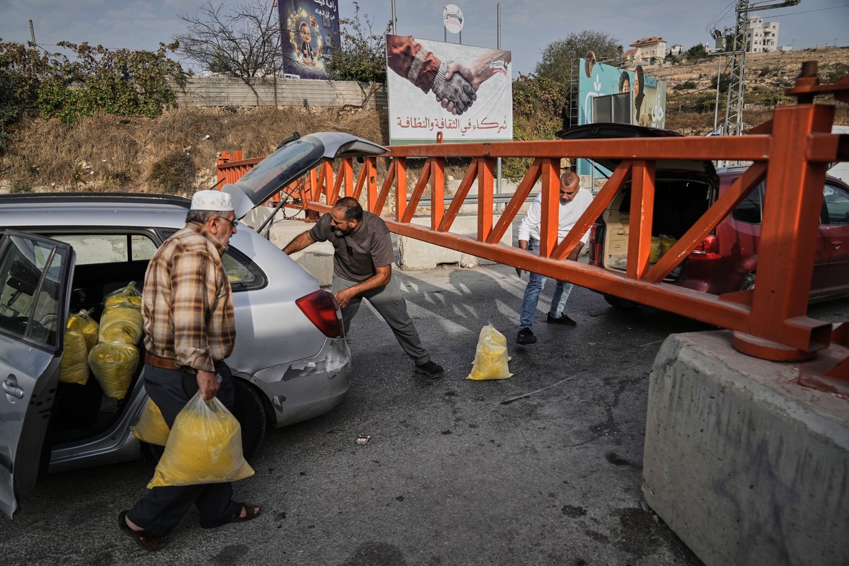 KEYPIX - Palestinians transport bags of semolina past a military gate closed to vehicles during an Israeli army operation in Hebron, in the occupied West Bank, Saturday, Oct. 24, 2026, a day after a P ...