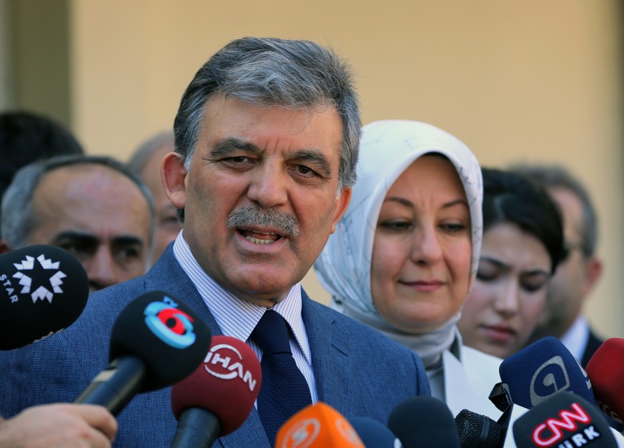 Turkey&#039;s President Abdullah Gul speaks to the media with his wife Hayrunnisa Gul after they have cast their votes for the Turkey&#039;s presidential election at a polling station in Ankara, Turke ...