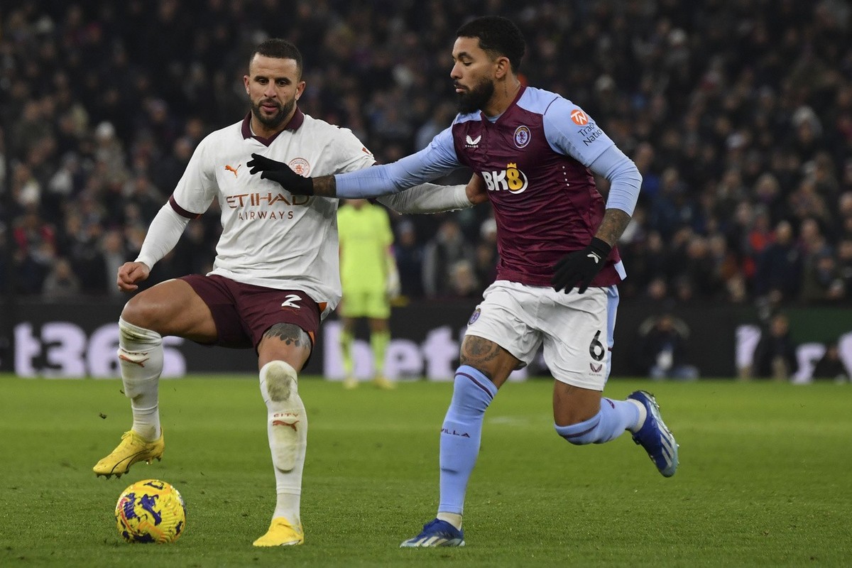 Manchester City's Kyle Walker, left, and Aston Villa's Douglas Luiz vie for the ball during the English Premier League soccer match between Aston Villa and Manchester City at Villa Park in B ...
