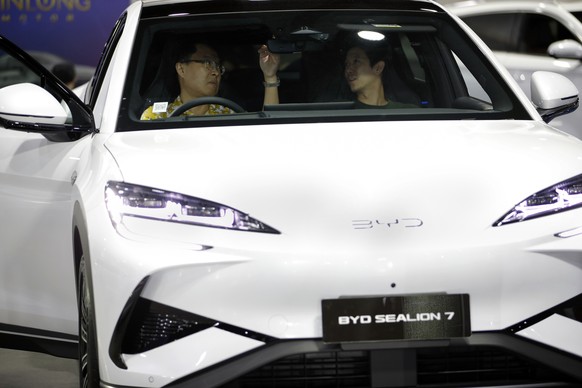 epa12478007 Potential customers inspect a BYD Sealion 7 electric vehicle at the Bangkok EV Expo 2025 in Bangkok, Thailand, 24 October 2025. The event showcases various electric car brands. EPA/RUNGROJ ...