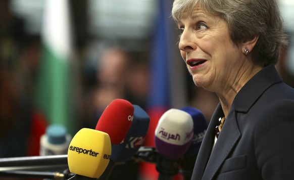 British Prime Minister Theresa May speaks with the media as she arrives for an EU summit in Brussels, Wednesday, Oct. 17, 2018. European Union leaders are converging on Brussels for what had been bill ...