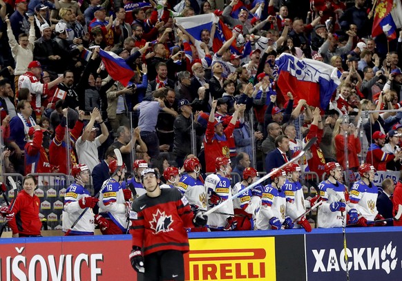 Russia&#039;s players celebrate a goal by Yevgeni Kuznetsov as Canada&#039;s Travis Konecny skates by at the Ice Hockey World Championships semifinal match between Canada and Russia in the LANXESS are ...