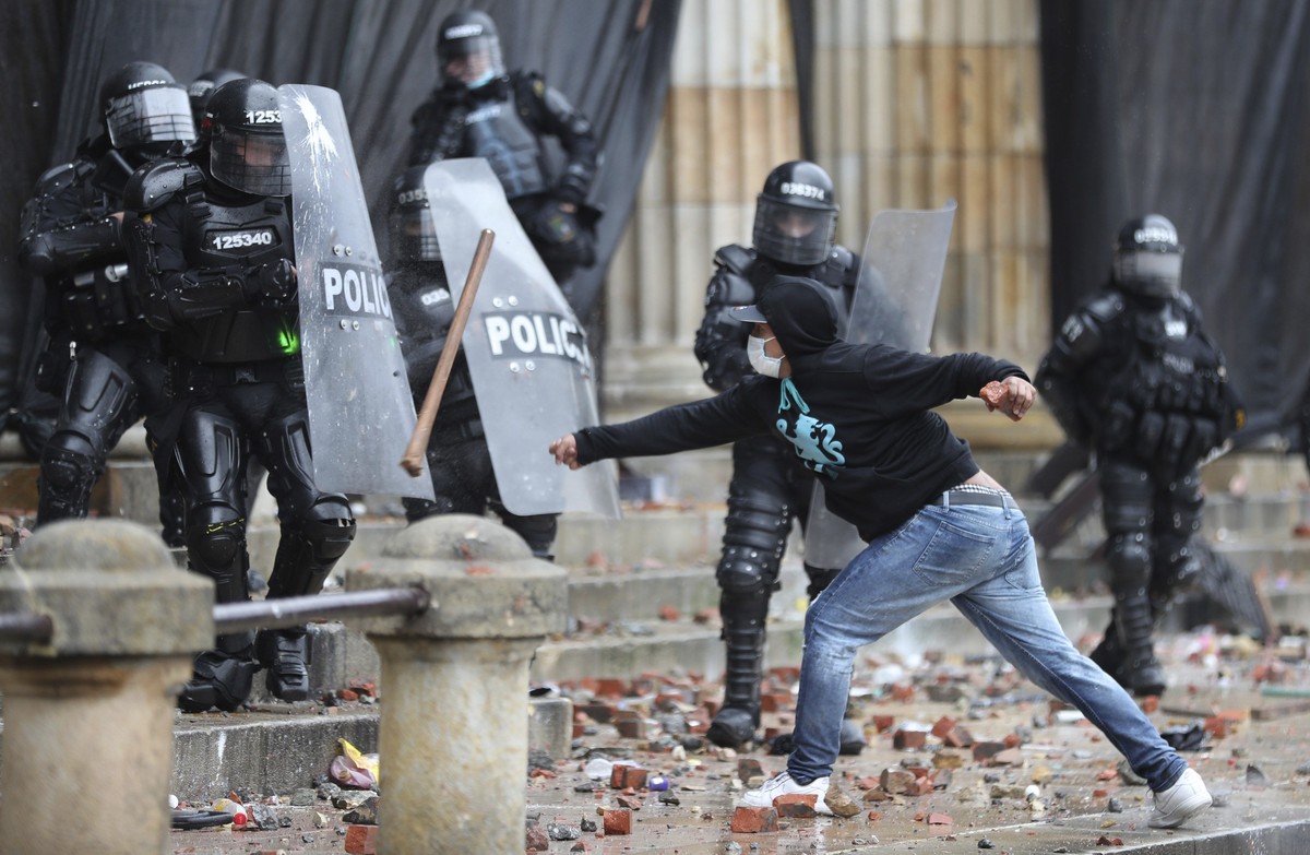 An anti-government protester clashes with police in Bogota, Colombia, Wednesday, May 5, 2021. The protests that began last week over a tax reform proposal continue despite President Ivan Duque's  ...