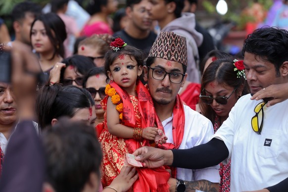 Toddler Aryatara Shakya Is Anointed As Kumari The Living Goddess After Undergoing Ancient Ritual Aryatara Shakya, two and a half years old, in red regalia, is carried by her father as she is brought t ...