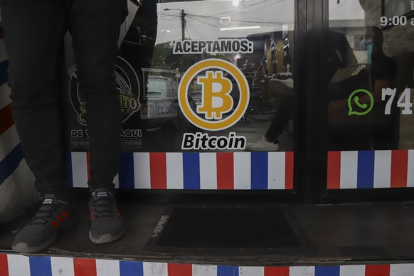 FILE - &quot;We accept Bitcoin&quot; is announced at a barber shop in Santa Tecla, El Salvador, Sept. 4, 2021. The IMF urged the government of El Salvador on Tuesday, Jan. 25, 2022 to eliminate Bitcoi ...