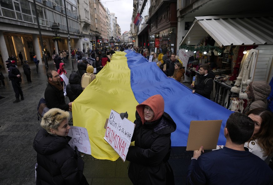 People hold a giant Ukrainian flag during a protest against the Russian invasion in Ukraine, in Belgrade, Serbia, Saturday, Feb. 26, 2022. Besides Belarus, Serbia is the only other European state that ...