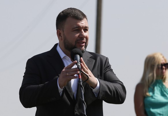 epa09350036 Head of the Donetsk People&#039;s Republic Denis Pushilin speaks during a mourning ceremony at the crash site of the MH17 plane, on the seventh anniversary of the disaster, near the pro-Ru ...