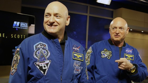 FILE - In this March 4, 2016, file photo, NASA astronaut Scott Kelly, left, and his twin Mark get together before a press conference in Houston. Scott Kelly set a U.S. record with his a 340-day missio ...