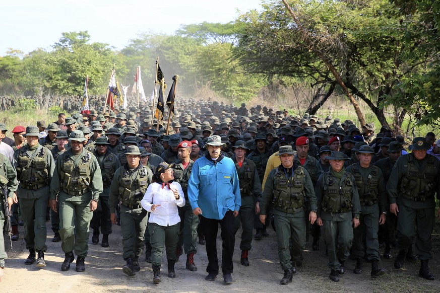 In this handout photo released by Miraflores Press Office, Venezuela&#039;s President Nicolas Maduro walks with troops at the G/J José Laurencio Silva training center in the state of Cojedes, Venezuel ...
