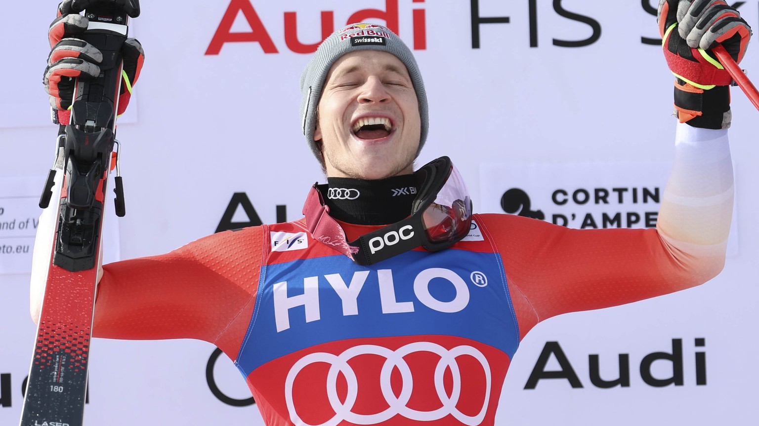 First placed Switzerland&#039;s Marco Odermatt celebrates on the podium at the end of an alpine ski, men&#039;s World Cup super-G, in Cortina d&#039;Ampezzo, Italy, Saturday, Jan. 28, 2023. (AP Photo/ ...
