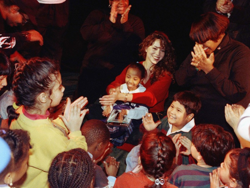 In December 1992, Mariah Carey attended the Police Athletic League (PAL) Christmas party in New York City, where she sang Christmas carols with the children. The event included gifts and a visit from  ...