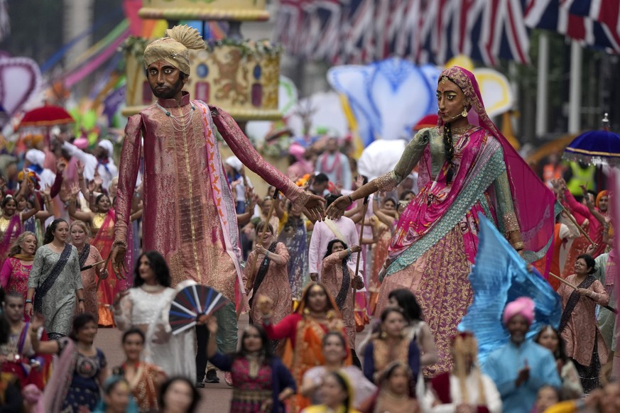 People parade during the Platinum Jubilee Pageant outside Buckingham Palace in London, Sunday, June 5, 2022, on the last of four days of celebrations to mark the Platinum Jubilee. The pageant will be  ...