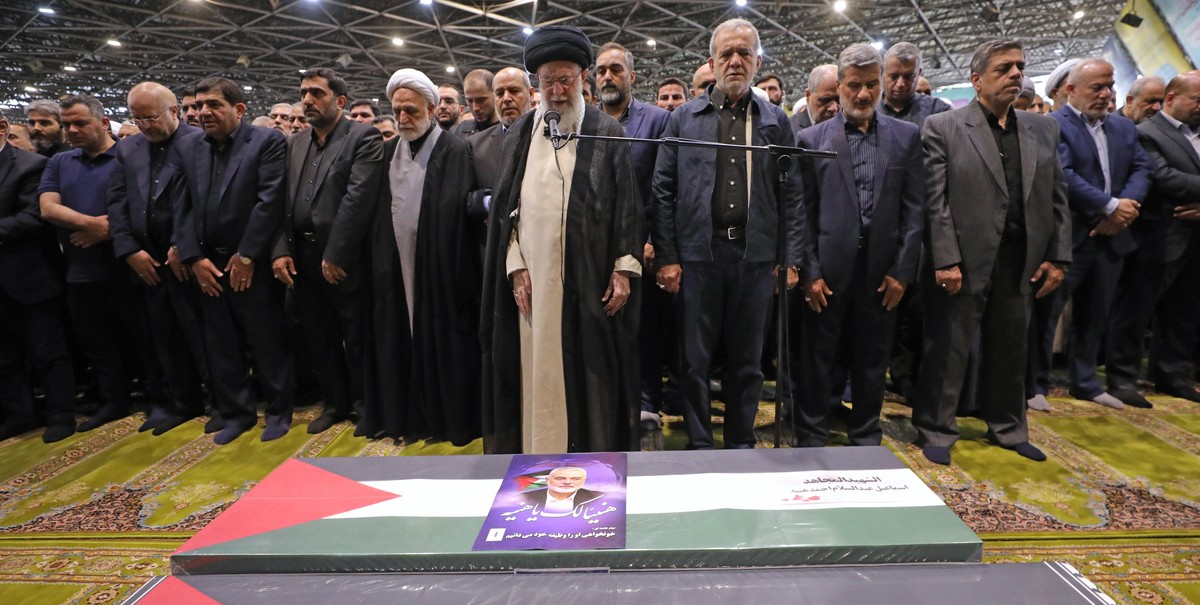 epa11515324 A handout photo made available by the Iranian Supreme Leader's Office shows Supreme Leader Ayatollah Ali Khamenei (front) leading a prayer before the coffins of late Hamas leader Isma ...