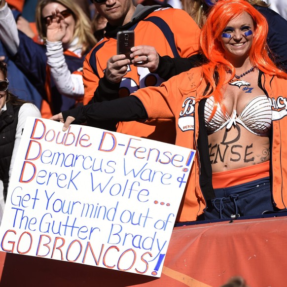 epa05123570 Denver Broncos fans hold placards prior to the start of the Broncos AFC Championship against the New England Patriots at Sports Authority Field at Mile High in Denver, Colorado, USA, 24 Ja ...