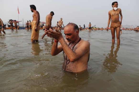 Hindu devotees take ritualistic dips in the Sangam, the confluence of three rivers â?? the Ganges, the Yamuna and the mythical Saraswati, during Makar Sankranti festival that falls during the annual t ...