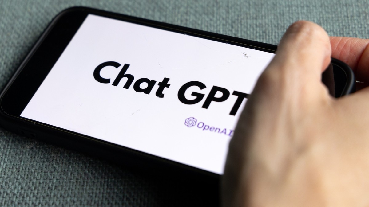 Woman's hand holding an iPhone with OpenAI logo. ChatGPT and Chat bot culture, artificial intelligence time. 01.01.2023 Amsterdam, Netherlands