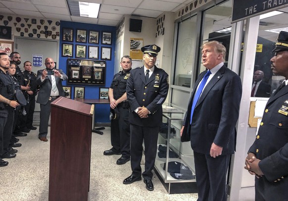 Former President Donald Trump, second from right, commemorated the 20th anniversary of the Sept. 11 attacks by visiting the NYPD&#039;s 17th police precinct in New York, where he criticized President  ...