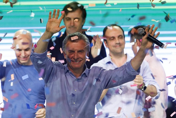 epa06283454 Argentinian President Mauricio Macri greets supporters at the Cambiemos headquarters, in Buenos Aires, Argentina, 22 October 2017. The governing Argentinean party Cambiemos swept in the ci ...